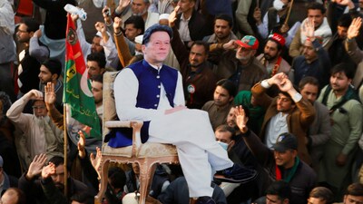 Supporters of the former Pakistani Prime Minister Imran Khan's party, the Pakistan Tehreek-e-Insaf (PTI), carry a cutout of him during a protest. (Reuters file photo)
