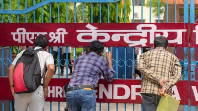 Relatives outside an examination centre ahead of the NEET UG exam 2025, in New Delhi, Sunday, May 4, 2025. (PTI) Relatives outside an examination centre ahead of the NEET UG exam 2025, in New Delhi, Sunday, May 4, 2025. (PTI)