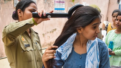 A police personnel checks an aspirant who arrived to appear for the NEET UG exam, in Meerut, Sunday, May 4, 2025. (PTI) A police personnel checks an aspirant who arrived to appear for the NEET UG exam, in Meerut, Sunday, May 4, 2025. (PTI)