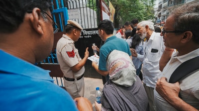 A police personnel check documents of an aspirant who arrived to appear for the NEET UG exam 2025, in New Delhi, Sunday, May 4, 2025. (PTI) A police personnel check documents of an aspirant who arrived to appear for the NEET UG exam 2025, in New Delhi, Sunday, May 4, 2025. (PTI)