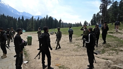 Security personnel inspect the site in the aftermath of an attack as food stall chairs lie empty in Pahalgam. (AFP) Security personnel inspect the site in the aftermath of an attack as food stall chairs lie empty in Pahalgam. (AFP)