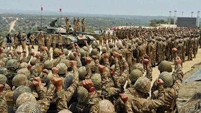 Pakistan's Army Chief Asim Munir, second left standing on tank, chant 'long live Pakistan' slogans with soldiers during his visit to witness military exercises, in Tilla Field Firing Range in the Jhelum district. (AP) Pakistan's Army Chief Asim Munir, second left standing on tank, chant 'long live Pakistan' slogans with soldiers during his visit to witness military exercises, in Tilla Field Firing Range in the Jhelum district. (AP)