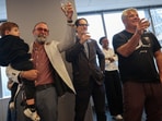 Reuters journalist Maurice Tasman holding his grandson Levi, Global Enterprise Editor Mike Williams and Senior Photographer Shannon Stapleton toast together after the Reuters staff was awarded a Pulitzer Prize in the Investigative Reporting category.