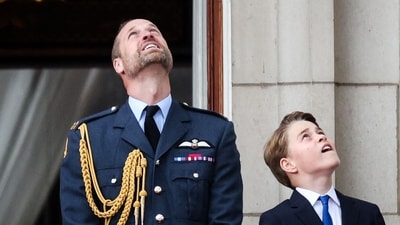 Prince William and Prince George looked on from the Buckingham Palace balcony as the Red Arrows soared overhead on May 5, 2025. (Photo by Adrian DENNIS / AFP) (AFP) Prince William and Prince George looked on from the Buckingham Palace balcony as the Red Arrows soared overhead on May 5, 2025. (Photo by Adrian DENNIS / AFP) (AFP)