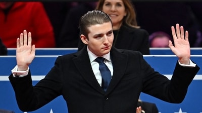Barron Trump gestures after being acknowledged by his father US President Donald Trump during the inaugural parade inside Capital One Arena, in Washington, DC, on January 20, 2025. (AFP) Barron Trump gestures after being acknowledged by his father US President Donald Trump during the inaugural parade inside Capital One Arena, in Washington, DC, on January 20, 2025. (AFP)