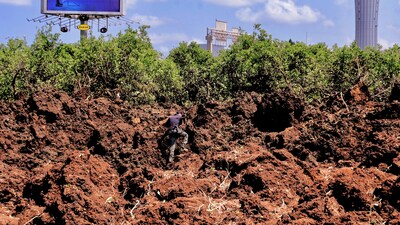 An Israeli police officer investigates a crater at the site of a missile attack, launched from Yemen, near Ben Gurion Airport, in Tel Aviv, Israel May 4, 2025. (REUTERS)