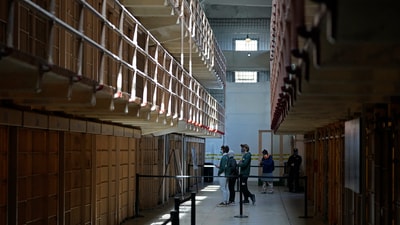 People tour the main cell house on Alcatraz Island in San Francisco, March 15, 2021, as the historic island prison was reopened to visitors after being closed since Dec. 2020, because of the coronavirus threat. (AP Photo/Eric Risberg, File) (AP) People tour the main cell house on Alcatraz Island in San Francisco, March 15, 2021, as the historic island prison was reopened to visitors after being closed since Dec. 2020, because of the coronavirus threat. (AP Photo/Eric Risberg, File) (AP)