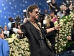 Shah Rukh Khan made his Met Gala debut, striking his signature pose on the blue carpet ahead of the opening of the "Superfine: Tailoring Black Style" exhibition on Monday, May 5, 2025, in New York. AP/PTI