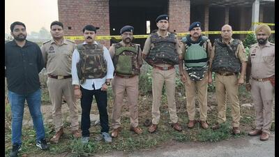 Police officials at the site of encounter in Agra on Tuesday. (HT photo)