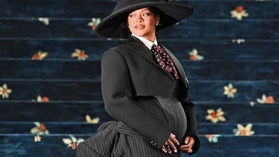 The founder of Fenty Beauty looked stunning in a wool bustier top, a cropped Marc Jacobs suit jacket, and a pinstripe skirt with a thigh-high slit and a sculptural bustle that mimicked the suit jacket. (Photo by Andrea RENAULT / AFP) (AFP) The founder of Fenty Beauty looked stunning in a wool bustier top, a cropped Marc Jacobs suit jacket, and a pinstripe skirt with a thigh-high slit and a sculptural bustle that mimicked the suit jacket. (Photo by Andrea RENAULT / AFP) (AFP)