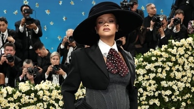 Rihanna accessorized the black-and-white ensemble with two-tone heels and wore her hair in a straight updo beneath a striking hat. For a dash of dandyism, she accessorized with a polka-dotted cravat. (Photo by Jamie McCarthy / GETTY IMAGES NORTH AMERICA / Getty Images via AFP) (Getty Images via AFP) Rihanna accessorized the black-and-white ensemble with two-tone heels and wore her hair in a straight updo beneath a striking hat. For a dash of dandyism, she accessorized with a polka-dotted cravat. (Photo by Jamie McCarthy / GETTY IMAGES NORTH AMERICA / Getty Images via AFP) (Getty Images via AFP)