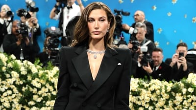 Hailey Bieber donned a black Saint Laurent blazer minidress and styled her beautiful brown hair in free waves as she walked the Met Gala 2025 red carpet on Monday, giving the impression that she was attending a Rhode Beauty event. (Getty Images via AFP) Hailey Bieber donned a black Saint Laurent blazer minidress and styled her beautiful brown hair in free waves as she walked the Met Gala 2025 red carpet on Monday, giving the impression that she was attending a Rhode Beauty event. (Getty Images via AFP)