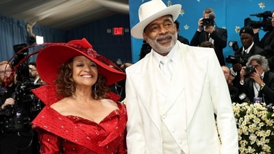 Debbie Allen and her spouse, Norm Nixon, completed their red and white ensembles with caps that matched. (Getty Images via AFP)