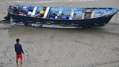 A Del Mar lifeguard looks over a capsized boat on the beach Monday at Torrey Pines State beach in San Diego, California. (AP) A Del Mar lifeguard looks over a capsized boat on the beach Monday at Torrey Pines State beach in San Diego, California. (AP)