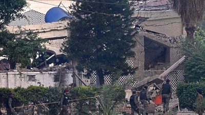 Paramilitary soldiers inspect the damaged building of the Government Health and Educational Complex after Indian strikes in Muridke, about 30 kilometers from Lahore, on May 7, 2025. (AFP)