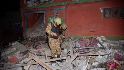 Army soldiers examine a building damaged by an Indian missile attack near Muzaffarabad. (AP)