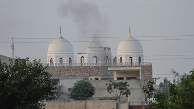 Local residents stand outside a mosque of an Islamic seminary partially damaged by an Indian missile attack, outskirts of Bahawalpur, Pakistan. India's response comes days after 26 people, mostly Hindus, were killed by terrorists in J&amp;K's Pahalgam. (AP)