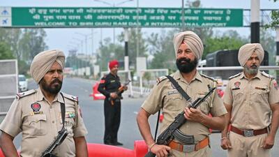 Policemen stand guard on the entrance road of the Sri Guru Ram Dass Jee International Airport on the outskirts of Amritsar on May 7. (AFP) Policemen stand guard on the entrance road of the Sri Guru Ram Dass Jee International Airport on the outskirts of Amritsar on May 7. (AFP)