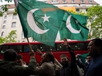 Demonstrators wave Pakistan's flags as they gather to protest outside the India High Commission, in London.