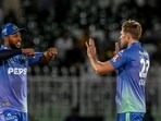Multan Sultans' David Willey (R) celebrates with teammate Chris Jordan after taking a wicket.