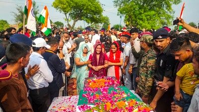 Family members mourn near the mortal remains of Lance Naik Dinesh Kumar of the Indian Army, who was killed in the Pakistani shelling along the Line of Control (LoC), in Palwal, Haryana, on Thursday (PTI)