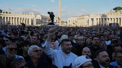 People react in St. Peter's square after white smoke poured from the chimney of the Sistine Chapel where 133 cardinals gathered on the second day of the conclave to elect a successor to late Pope Francis, at the Vatican, Thursday, May 8, 2025 (AP Photo/Alessandra Tarantino) (AP) People react in St. Peter's square after white smoke poured from the chimney of the Sistine Chapel where 133 cardinals gathered on the second day of the conclave to elect a successor to late Pope Francis, at the Vatican, Thursday, May 8, 2025 (AP Photo/Alessandra Tarantino) (AP)