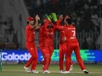 Islamabad United' s Shadab Khan(R) celebrates the wicket of Multan Sultans' Mohammad Rizwan (not pictured) during the Pakistan Super League (PSL) 