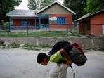 A boy walks past a school after schools remained closed for the second day following clashes between India and Pakistan, in Srinagar on May 8, 2025.