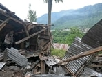 A local resident inspects the debris of his house that was destroyed by Pakistani artillery shelling at the Lagama village in Uri.