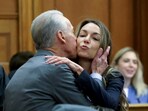 William Read kisses his daughter, Karen, before the start of her murder trial in Norfolk Superior Court in Dedham
