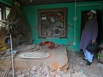 After a wave of Pakistani shelling, a resident in Uri examines his home which has been destroyed.