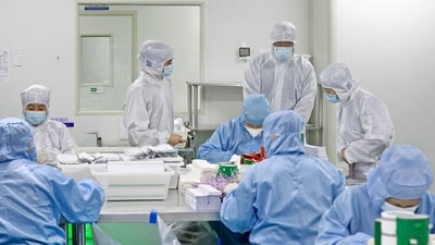 People in PPE kits during the Covid-19 pandemic in 2021. (AFP) People in PPE kits during the Covid-19 pandemic in 2021. (AFP)