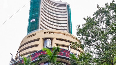 People walk past the Bombay Stock Exchange (BSE) building, in Mumbai, on May 7, 2025. (PTI)