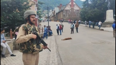 Cop stands guard on Mall Road in Shimla on Friday. (HT Photo) Cop stands guard on Mall Road in Shimla on Friday. (HT Photo)