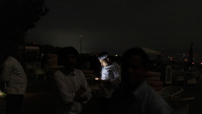 A hotel staff uses a moblie phone as others look for shelter amid a Pakistan attack in Jammu, May 8, 2025. (REUTERS)