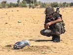 A security person is inspecting the debris of a projectile in Rajasthan’s Jaisalmer. A security person is inspecting the debris of a projectile in Rajasthan’s Jaisalmer.