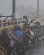 Bikers take cover on the side of a road amid heavy rainfall in Ghaziabad on May 8. (PTI Photo) Bikers take cover on the side of a road amid heavy rainfall in Ghaziabad on May 8. (PTI Photo)