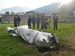 People look at a damaged part of an aircraft in Wuyan, near Srinagar. India and Pakistan exchanged heavy artillery along their contested frontier on May 7. People look at a damaged part of an aircraft in Wuyan, near Srinagar. India and Pakistan exchanged heavy artillery along their contested frontier on May 7.