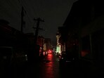 Vehicles stand parked on a road during blackout in Srinagar on Friday. Vehicles stand parked on a road during blackout in Srinagar on Friday.