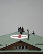 Workers paint a red cross symbol over the roof of a hospital in Srinagar amid tension along the border. (AFP) Workers paint a red cross symbol over the roof of a hospital in Srinagar amid tension along the border. (AFP)