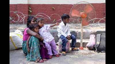 A family of a migrant worker sits outside a railway station before boarding a train in Jammu. (REUTERS) A family of a migrant worker sits outside a railway station before boarding a train in Jammu. (REUTERS)