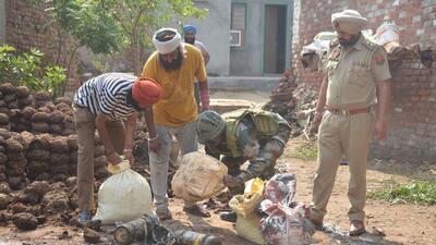 Army and Punjab Police personnel collecting the debris of a projectile found at Wadala Bhittewad village in Amritsar district on Saturday morning. (Sameer Sehgal/HT) Army and Punjab Police personnel collecting the debris of a projectile found at Wadala Bhittewad village in Amritsar district on Saturday morning. (Sameer Sehgal/HT)