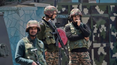 Indian army soldiers stand guard after loud explosions were heard in Srinagar. (AP) Indian army soldiers stand guard after loud explosions were heard in Srinagar. (AP)