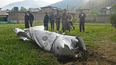 People look at a damaged part of an aircraft in Wuyan, near Srinagar. India and Pakistan exchanged heavy artillery along their contested frontier on May 7. (AFP) People look at a damaged part of an aircraft in Wuyan, near Srinagar. India and Pakistan exchanged heavy artillery along their contested frontier on May 7. (AFP)
