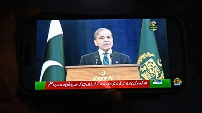 A resident watches his smartphone as Pakistan's Prime Minister Shehbaz Sharif addresses the nation in Islamabad on May 10, 2025. Pakistan and India agreed on May 10 to a full and immediate ceasefire after days of military clashes. (AFP) A resident watches his smartphone as Pakistan's Prime Minister Shehbaz Sharif addresses the nation in Islamabad on May 10, 2025. Pakistan and India agreed on May 10 to a full and immediate ceasefire after days of military clashes. (AFP)