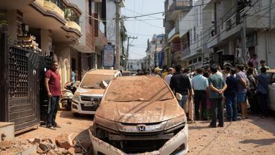 People standing next to a damaged vehicle in a neighbourhood in Rehari Colony of Jammu after it was hit by Pakistani projectiles on Saturday morning. (Reuters) People standing next to a damaged vehicle in a neighbourhood in Rehari Colony of Jammu after it was hit by Pakistani projectiles on Saturday morning. (Reuters)