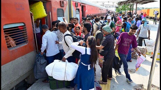 Murali Kumar, a factory worker, was heading back to Lucknow with his son. He said they’ve been working here for years, but felt safer to be back home right now (Gurpreet Singh/HT)
