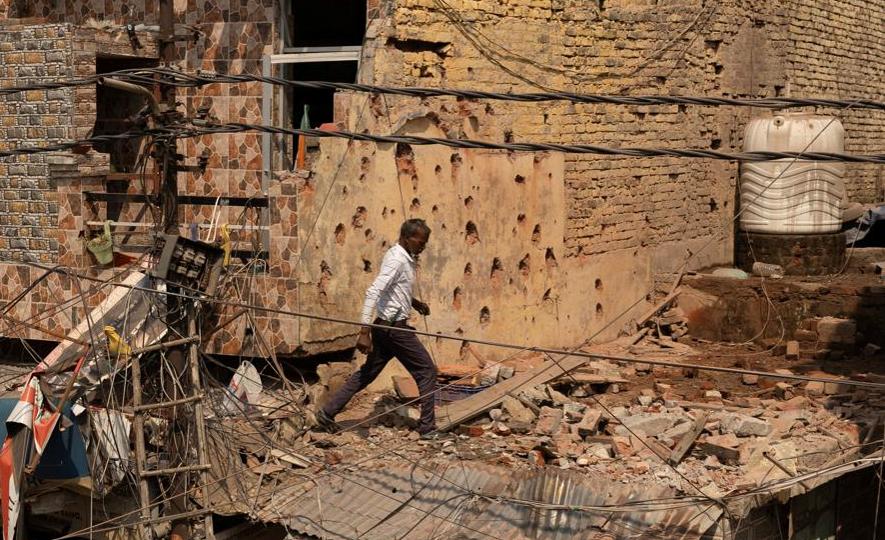 A man walks amid debris on the roof of a damaged house in the Rehari locality of Jammu after it was hit by Pakistani projectiles on Saturday morning. (Reuters) A man walks amid debris on the roof of a damaged house in the Rehari locality of Jammu after it was hit by Pakistani projectiles on Saturday morning. (Reuters)