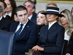 Barron Trump and First Lady Melania Trump listen as US President Donald Trump delivers remarks after being sworn in as the 47th President.