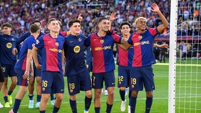 Barcelona's players celebrate victory at the end of the Spanish league football match between FC Barcelona and Real Madrid CF (AFP)